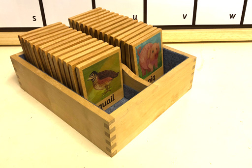 Alphabet tiles in a wooden box
